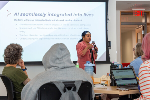 Betty Chandy leads a discussion in a classroom.