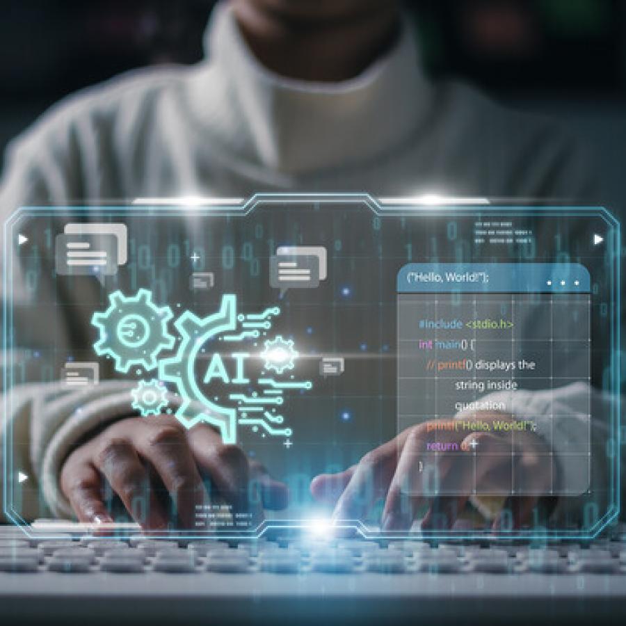 A person using AI on computer keyboard.
