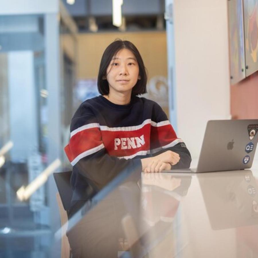 Rachel Liu sitting at a counter with her laptop.